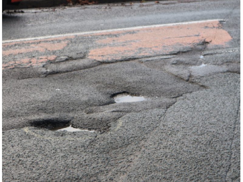 Potholes on Northcote Road near the junction with Windsor Place, in Mangotsfield