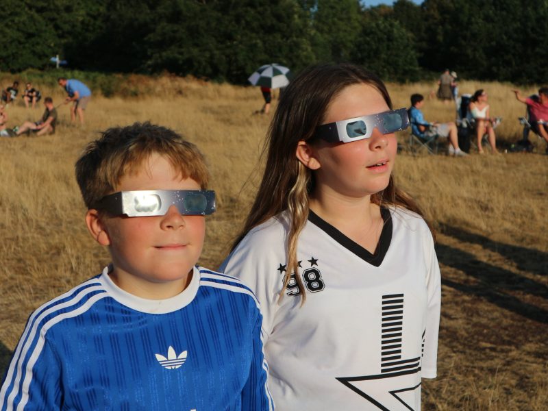 Olivia and Zac Bence, from Kingswood, watch the eclipse from Rodway Common, Mangotsfield